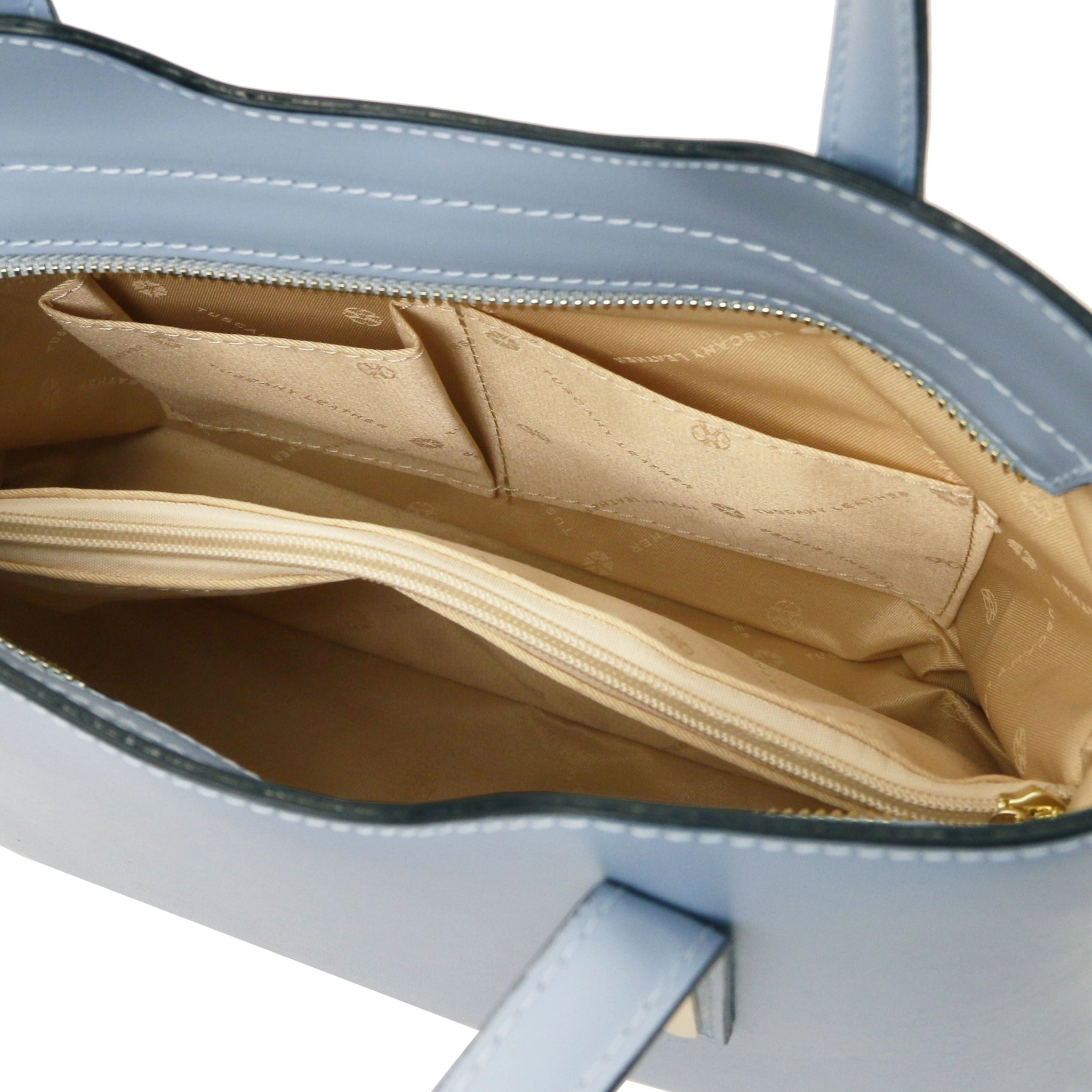 Interior Open Pockets View Olimpia Leather Tote in Light Blue Small Size showing beige lining