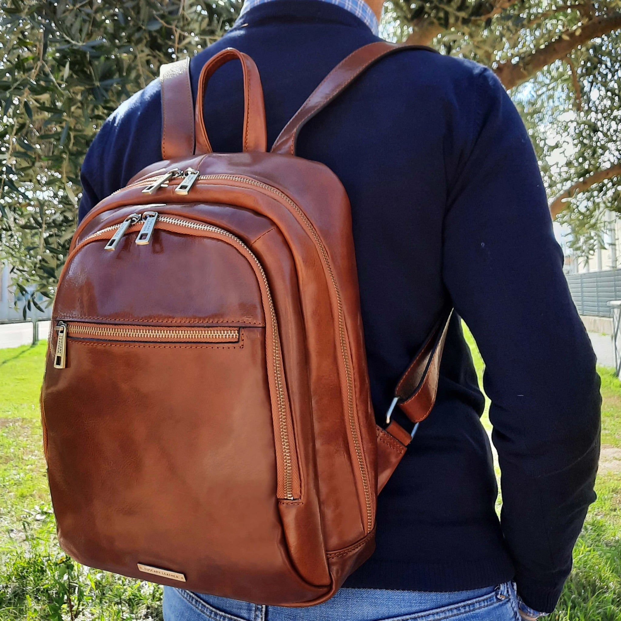 Male model wearing Perth Two Compartments Leather Backpack in Brown on his back