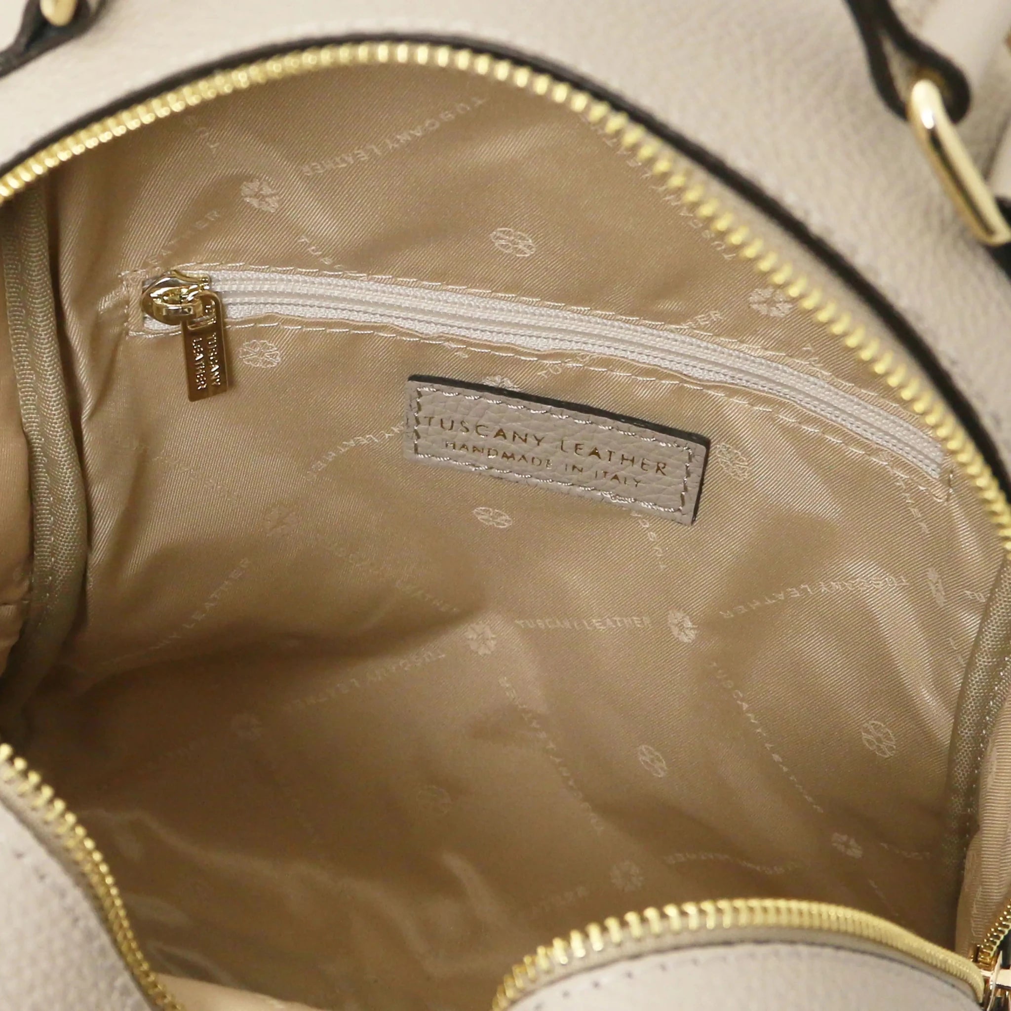 Interior zip Prisma Leather Backpack in light taupe with beige lining.