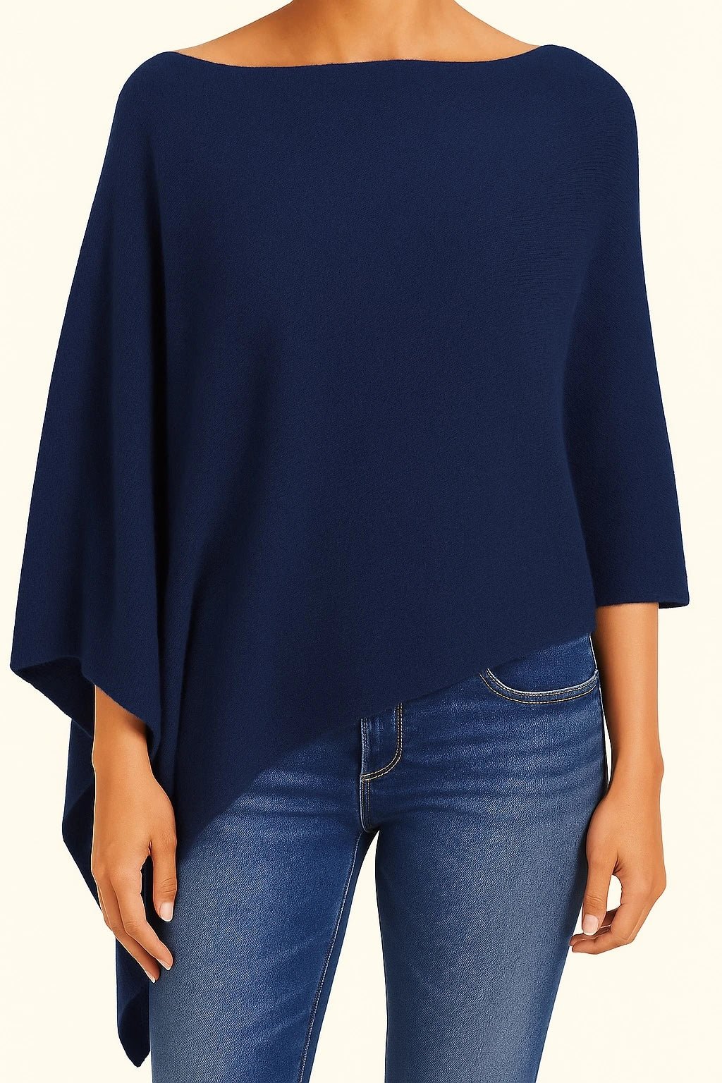 A model wearing the Ravello Cashmere Poncho in indigo on blue jeans
