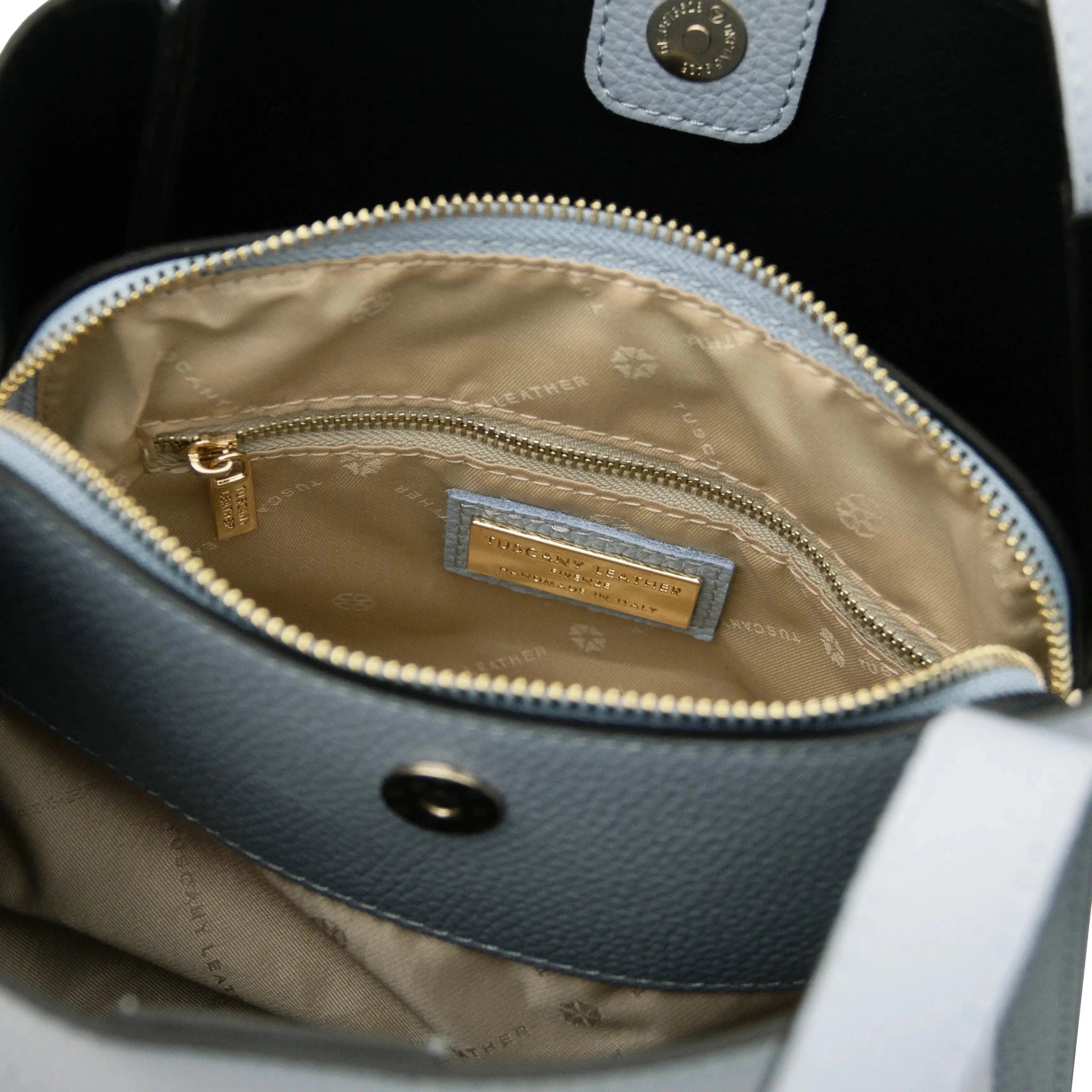 Interior zip pocket beige lining view Soave Soft Leather Handbag in light blue on a white background