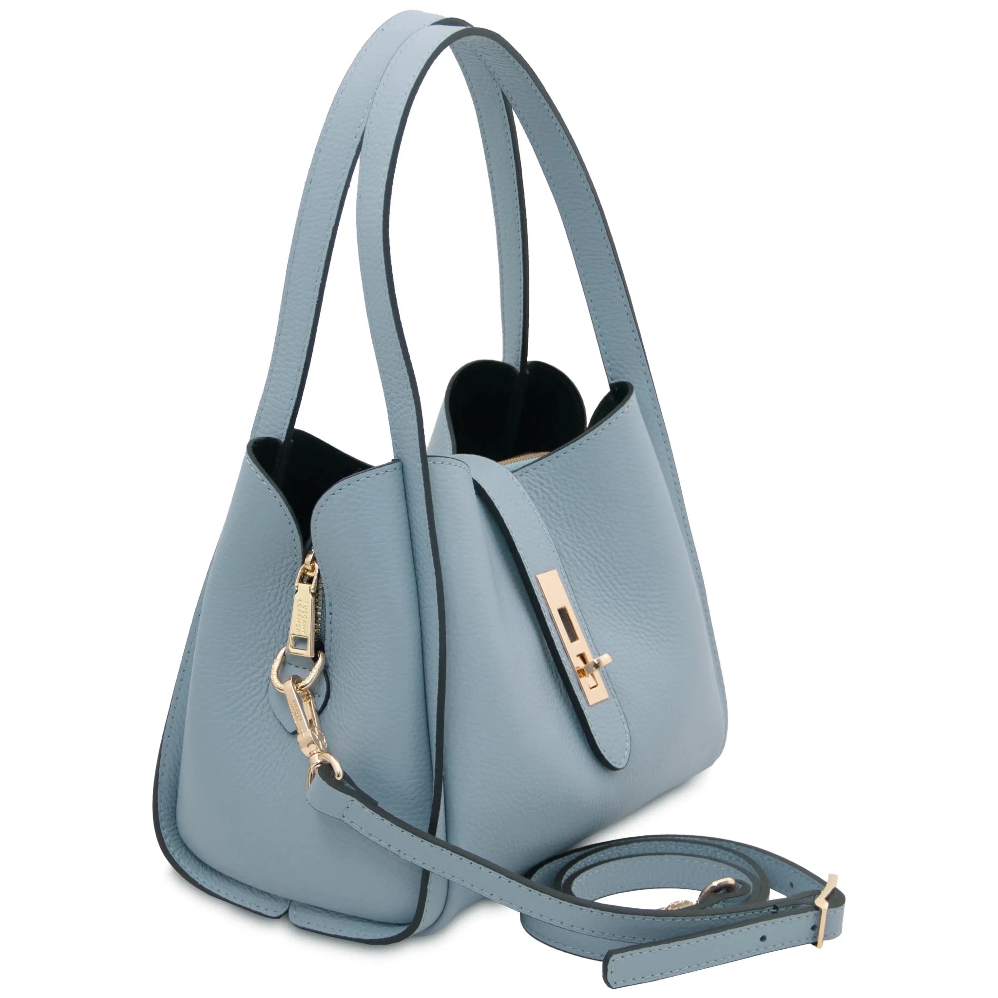 Front angled view Soave Leather Handbag in light blue with shoulder strap on white background