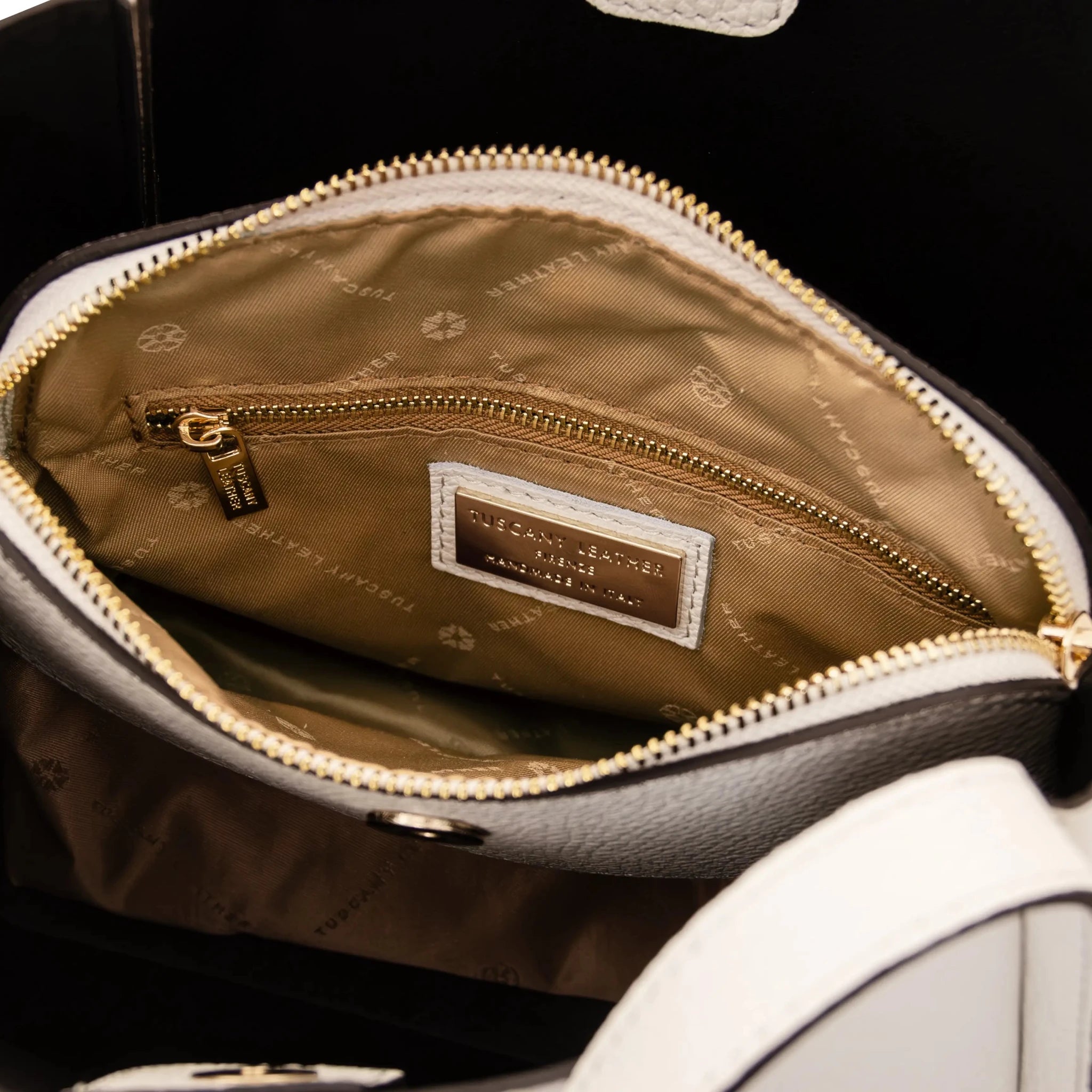 Interior zip pocket tan lining view Soave Soft Leather Handbag in beige on a white background