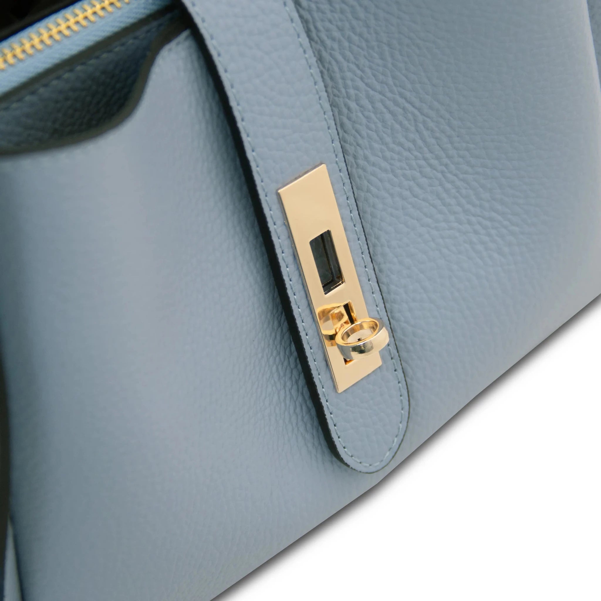 Close up twist lock view Soave Soft Leather Handbag in light blue on a white background