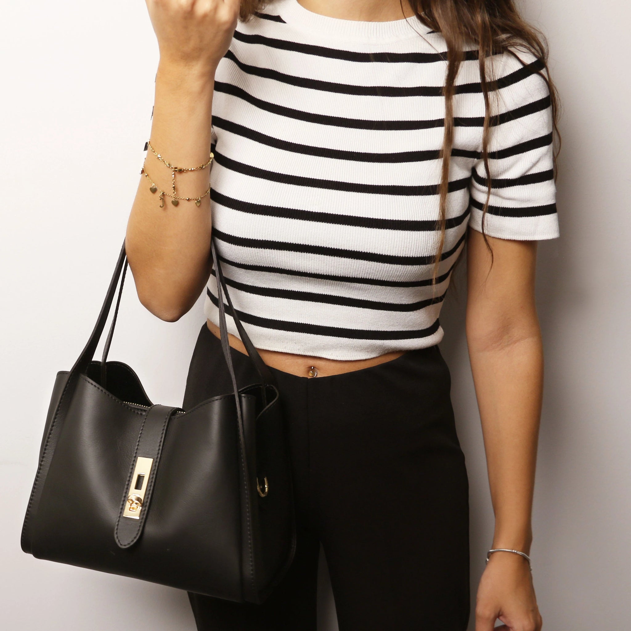 Model holding Soave Soft Leather Handbag in Black