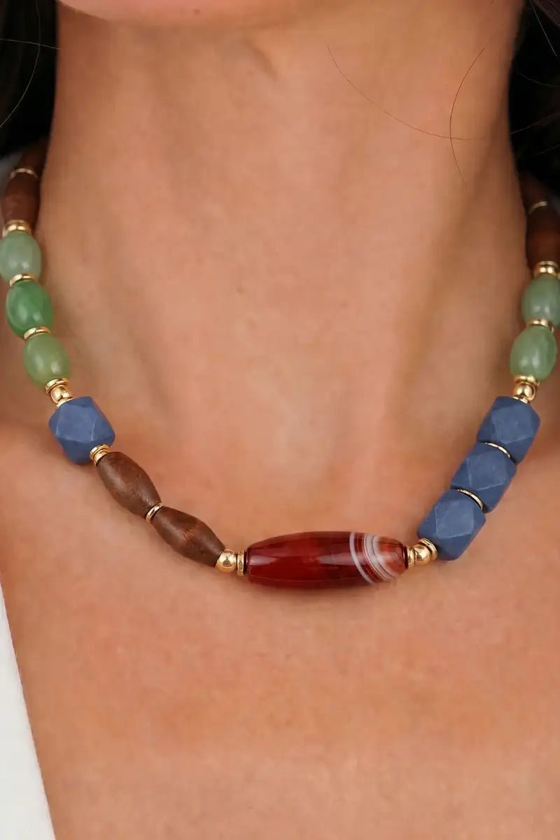 Necklace with multicolored beads on a person's neck