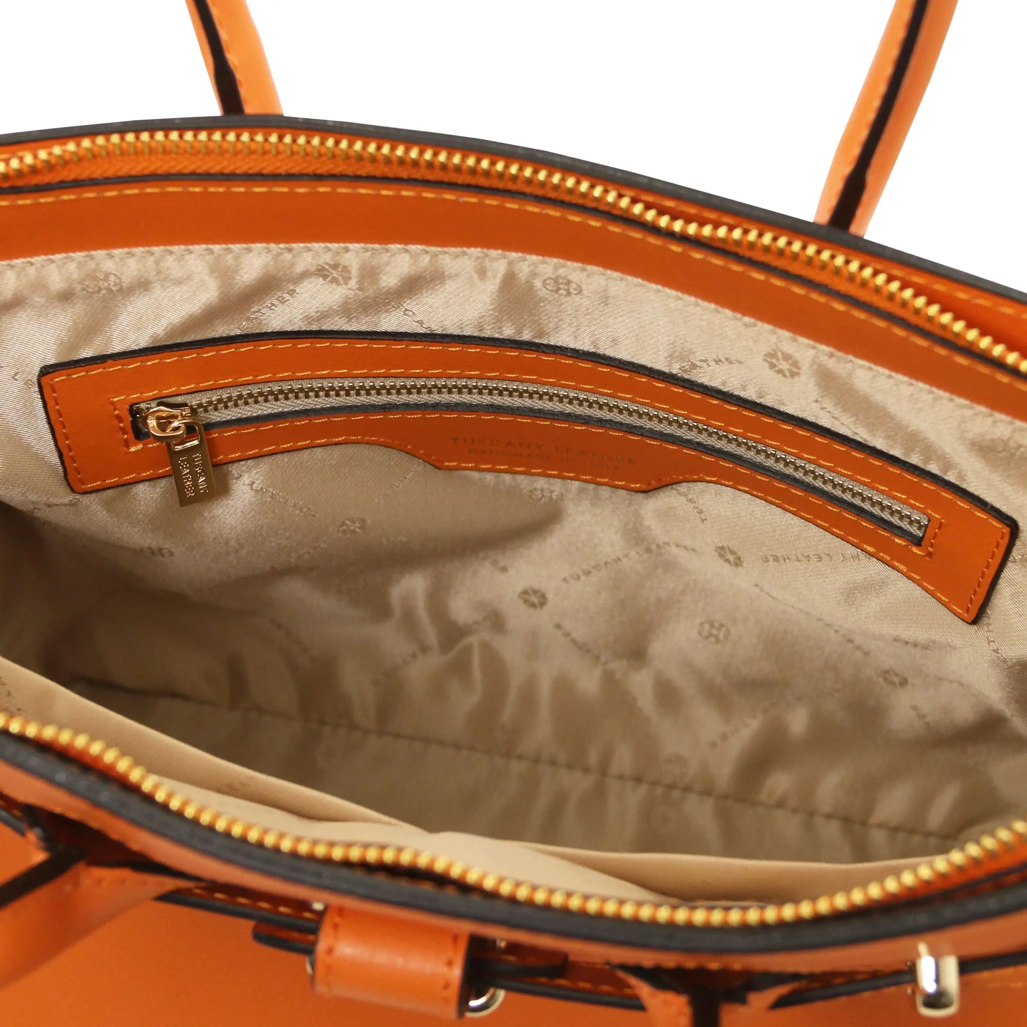 Interior zip pocket view TL Bag in Orange with light beige lining