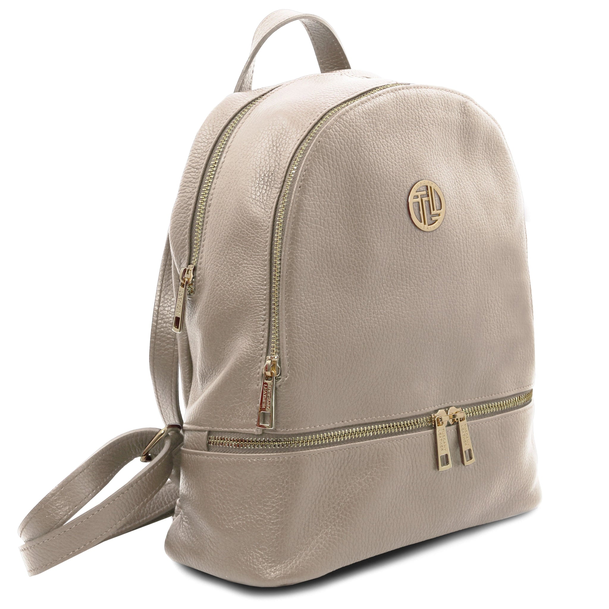 Side angled view of the TL Bag Italian Soft Leather Zip Backpack in light taupe showingtop handle and backpack straps