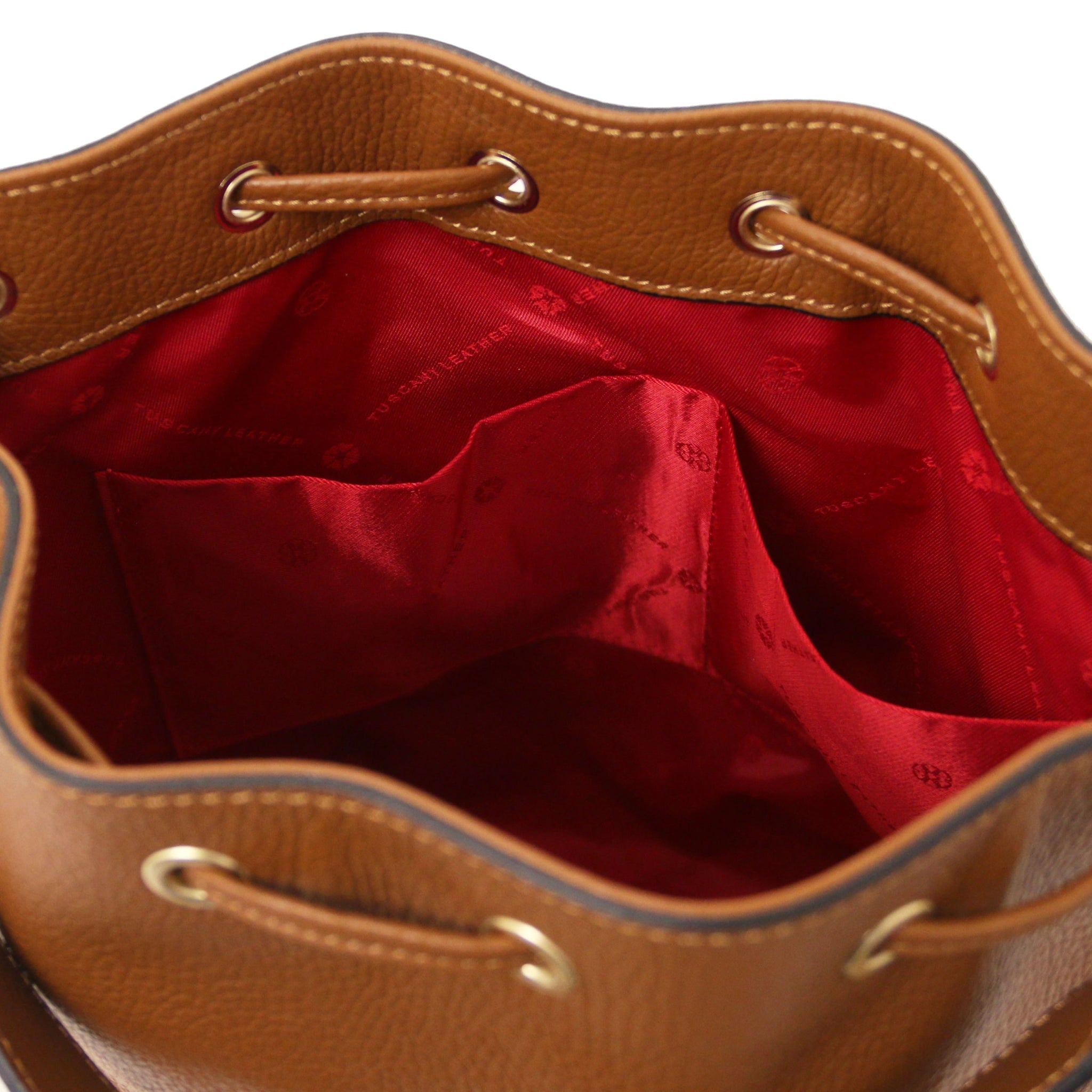 Interior open pocket view of TL Italian Leather Bucket Bag in cognac showing red lining