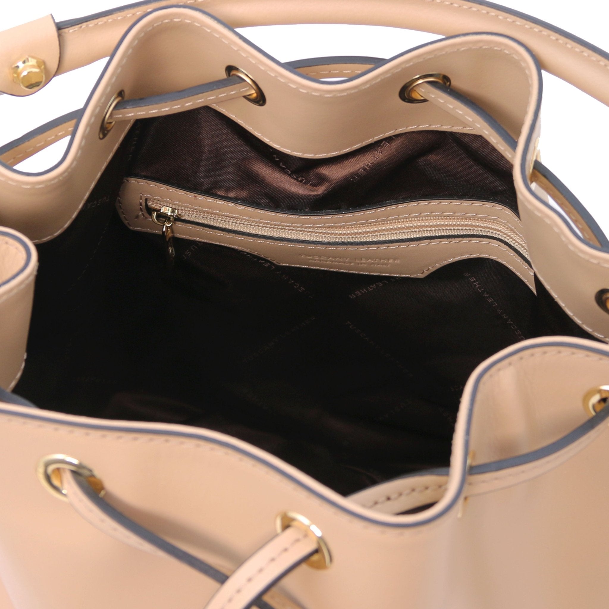 Interior zippered pocket view of Vittoria Leather Bucket Bag in champagne on a white background - L'Atelier Global