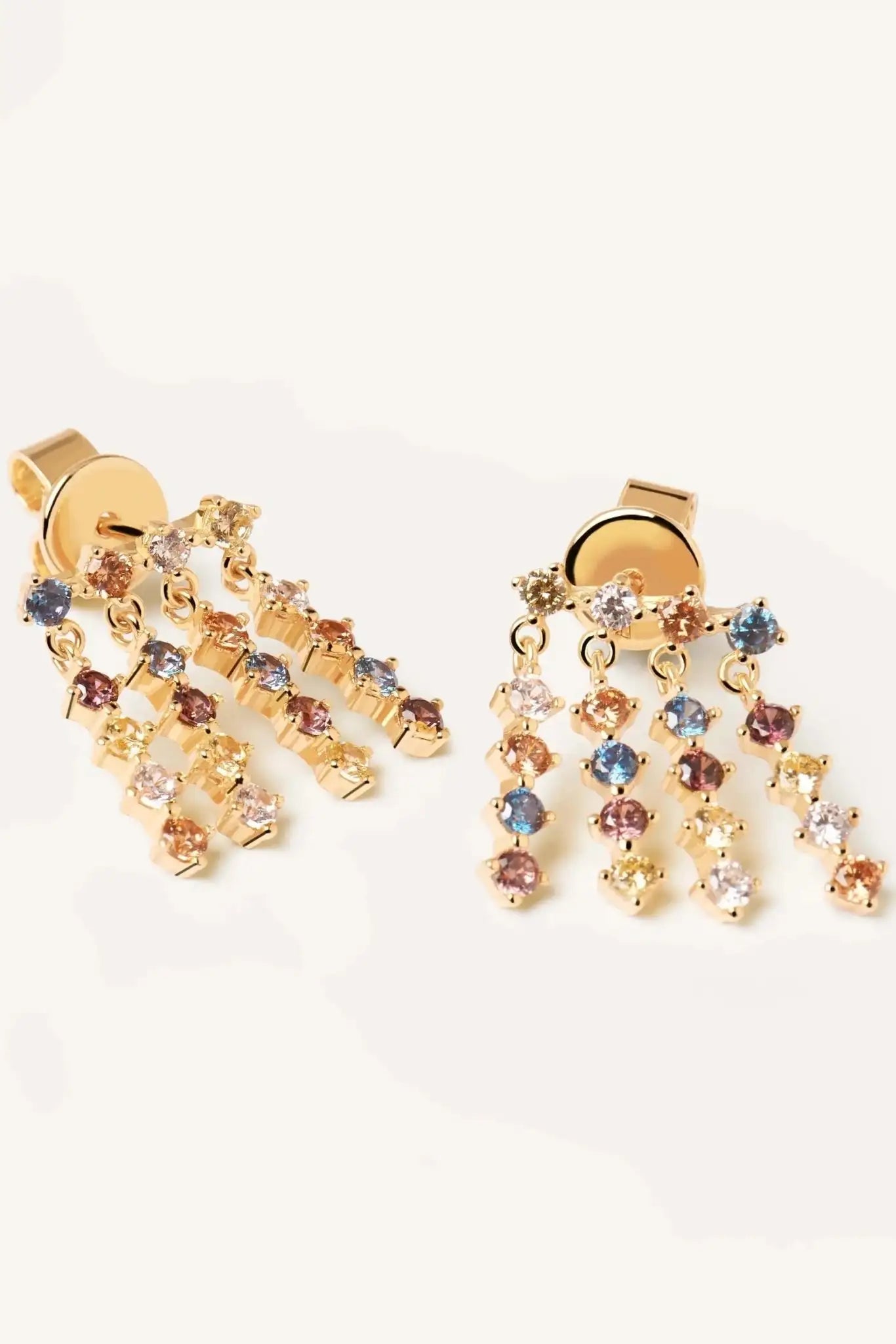 Gold earrings with multicolored gemstones on a white background