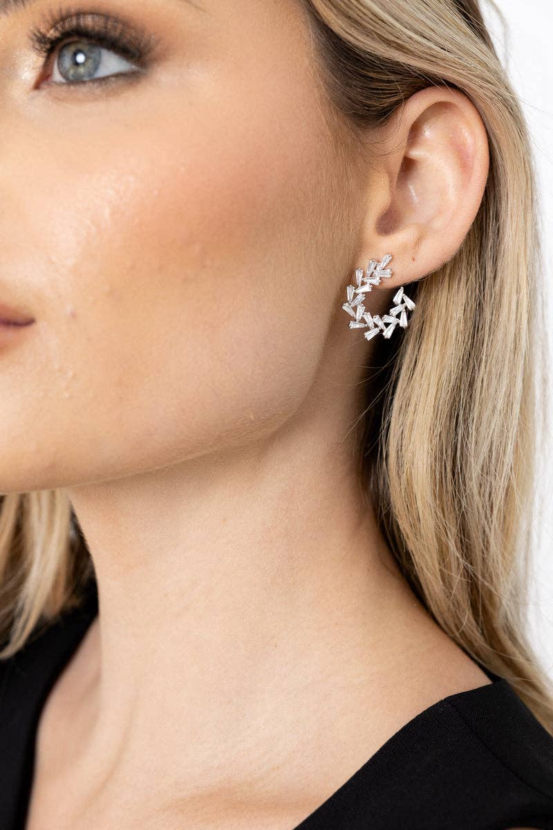 Arianna Sculpted Baguette CZ Earrings in silver worn by a model with long blonde hair. She is showing her left ear close up.