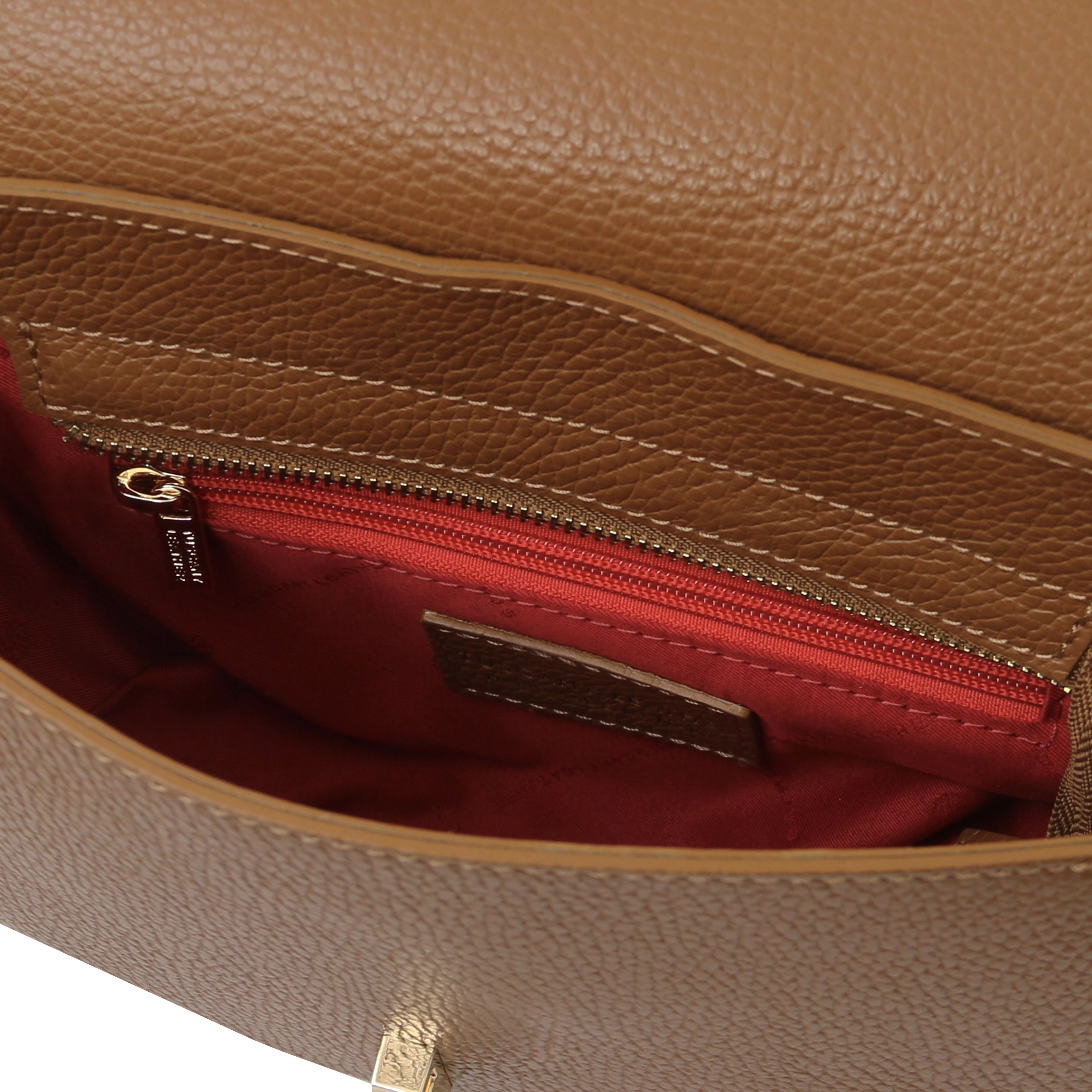 Interior zip pocketsview Astrea Leather Shoulder Bag in cognac on a white background