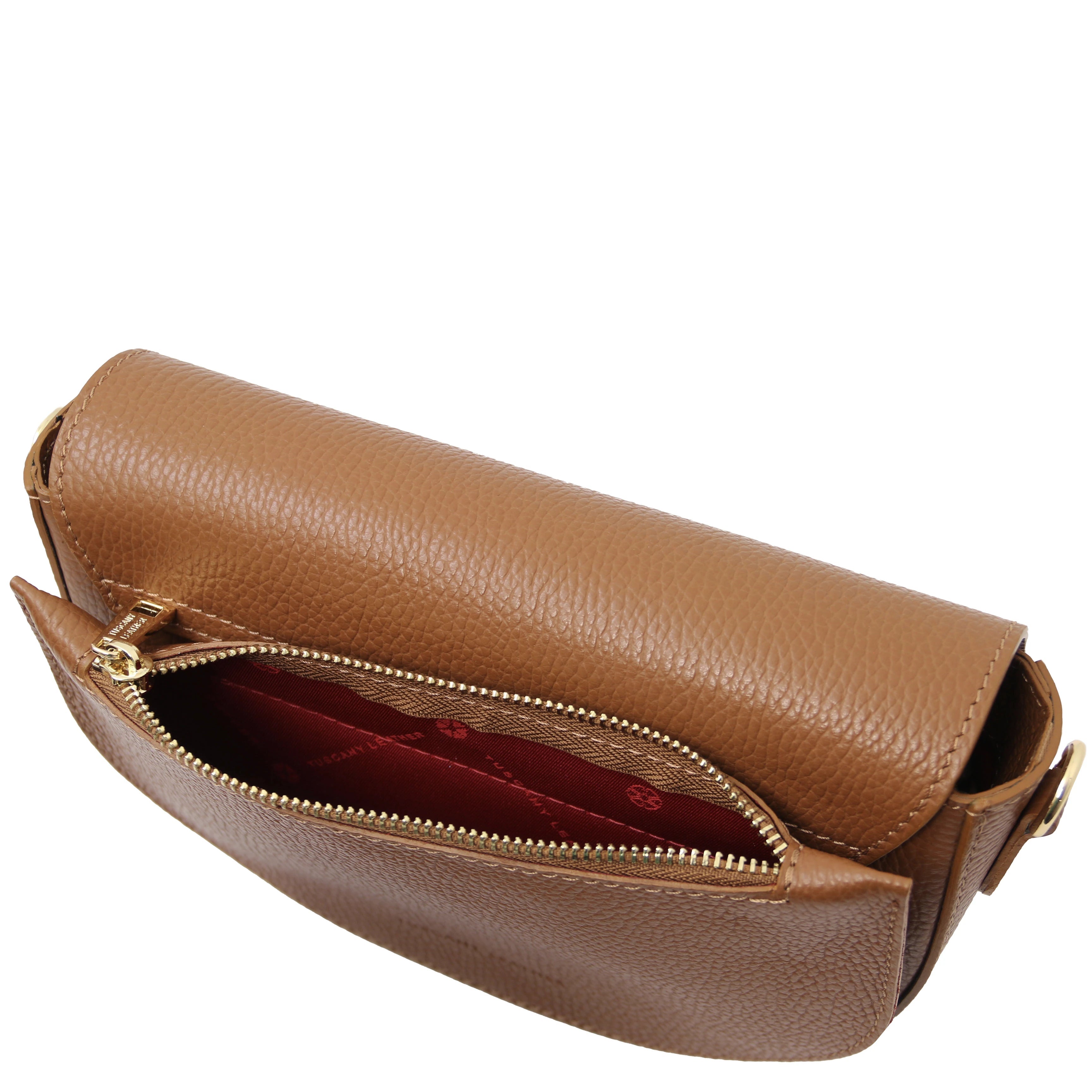 Exterior back zippered pocket view Astrea Leather Shoulder Bag in cognac on a white background