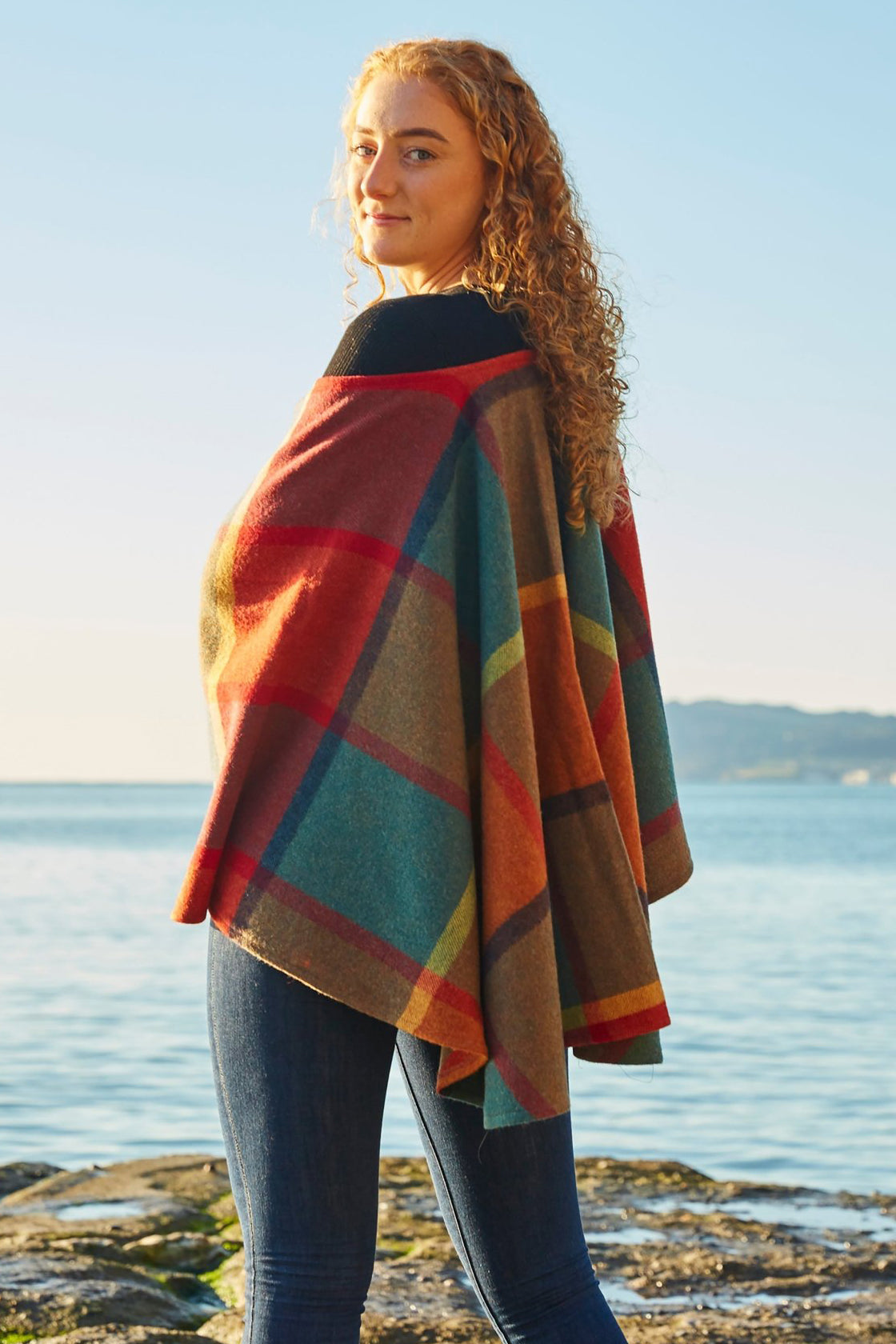 Autumn Splendor Lambswool Ruana Wrap on a Female Model with the Ocean Behind Her