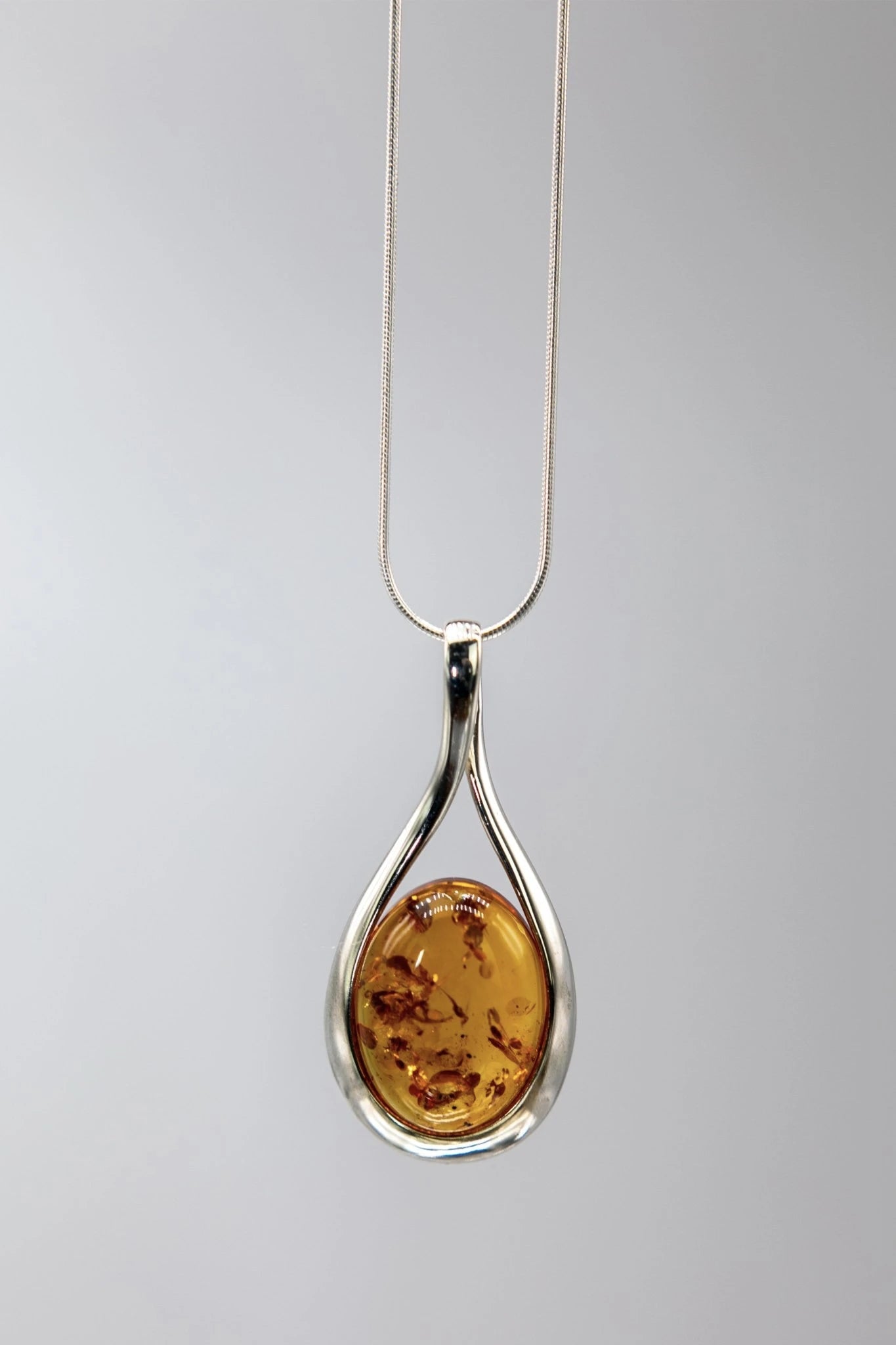 Baltic Honey Amber Sculptured Tear Drop Necklace on Gray - L'Atelier Global