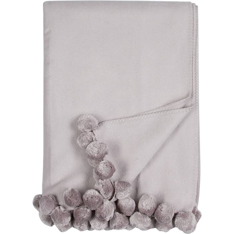 Bamboo Luxxe Pom Pom Throw in light gray folded on a white background - L'Atelier Global