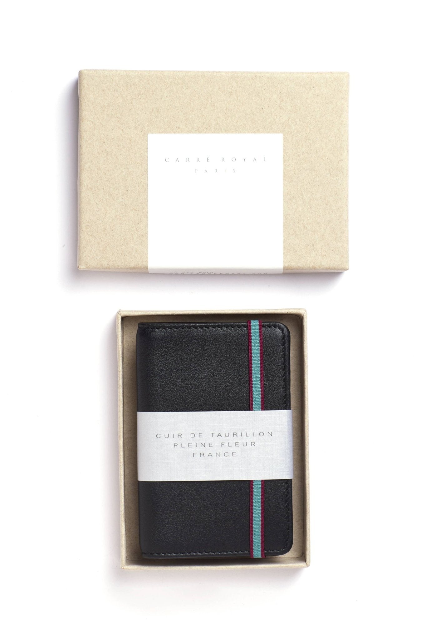 The Black Leather Card Holder with a blue elastic closure and box on a white background - L'Atelier Global