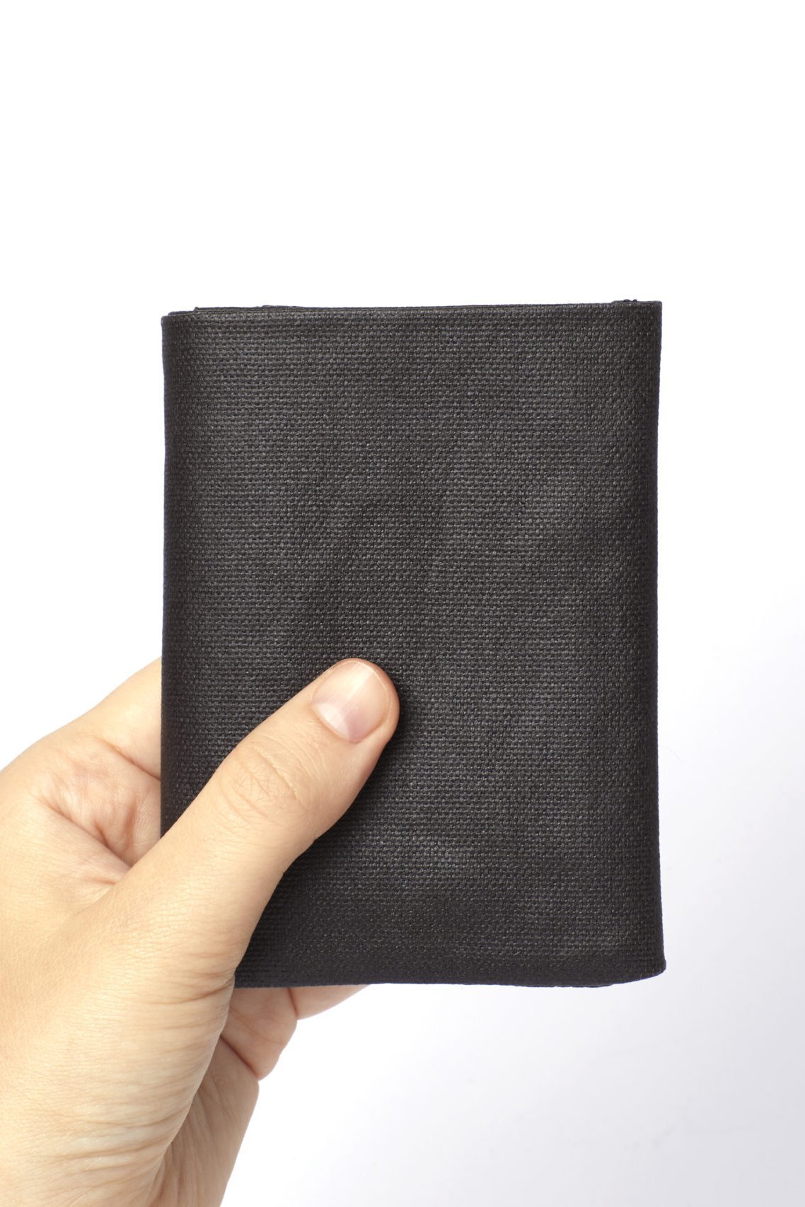 A man's hand holding the Brown Minimalist Canvas and Leather Wallet on a white background - L'Atelier Global