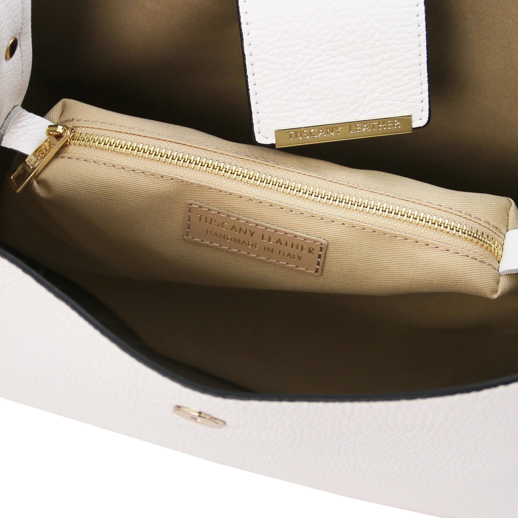 Interior central zippered compartment and light tan lining view of the Clio Italian Pebbled Leather Secchiello Bag in White