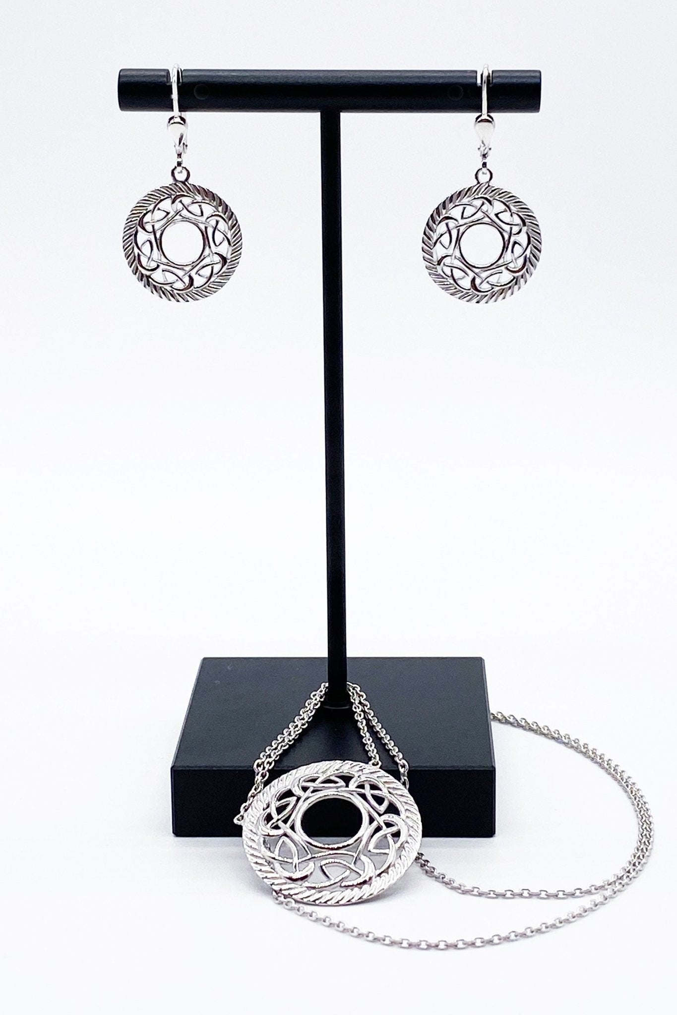 Open Knot Sterling Silver Earrings and matching necklace styled on black metal jewelry stand - L'Atelier Global