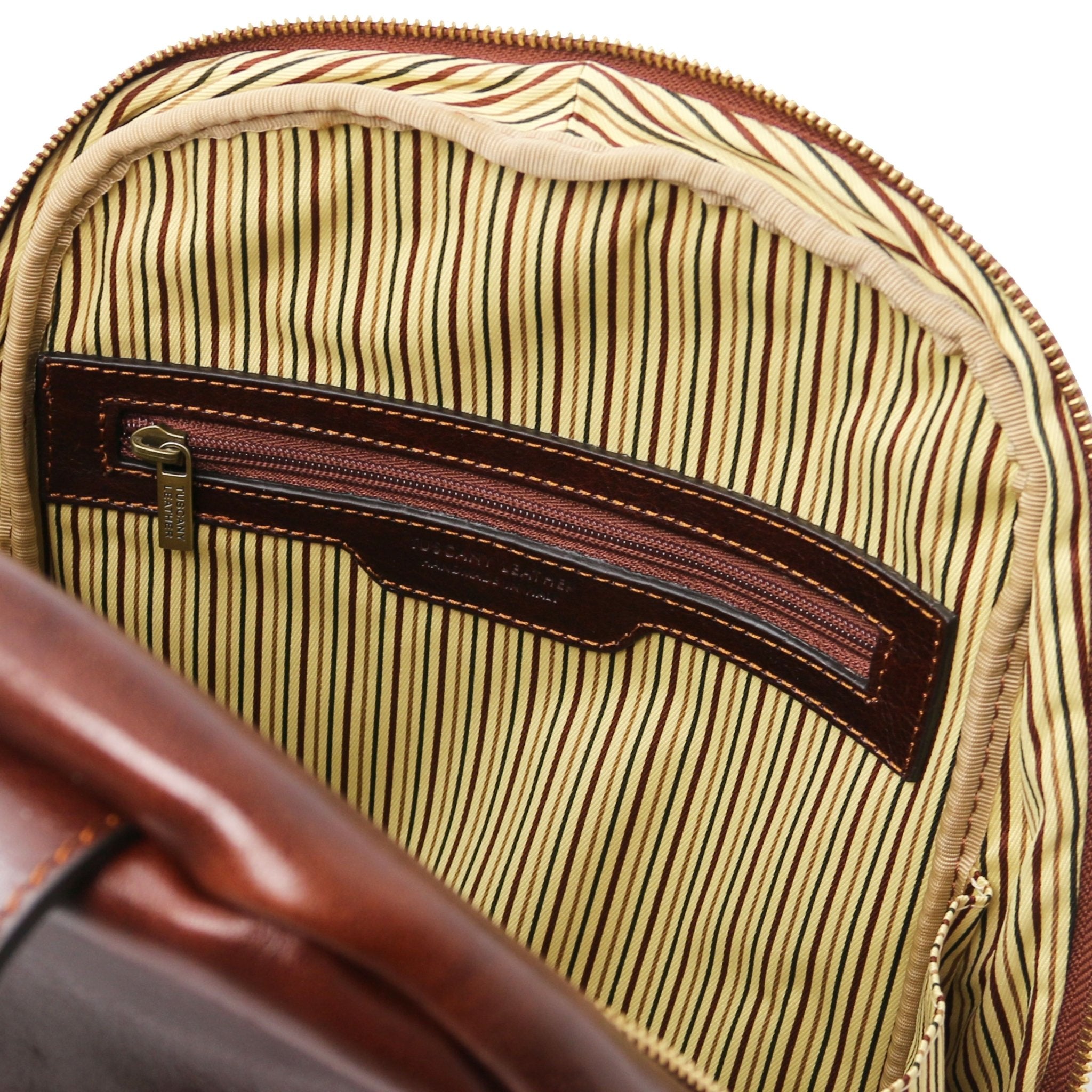 Interior view main entry Perth Two Compartments Leather Backpack in Brown showing zippered pocket and striped cotton ticking lining