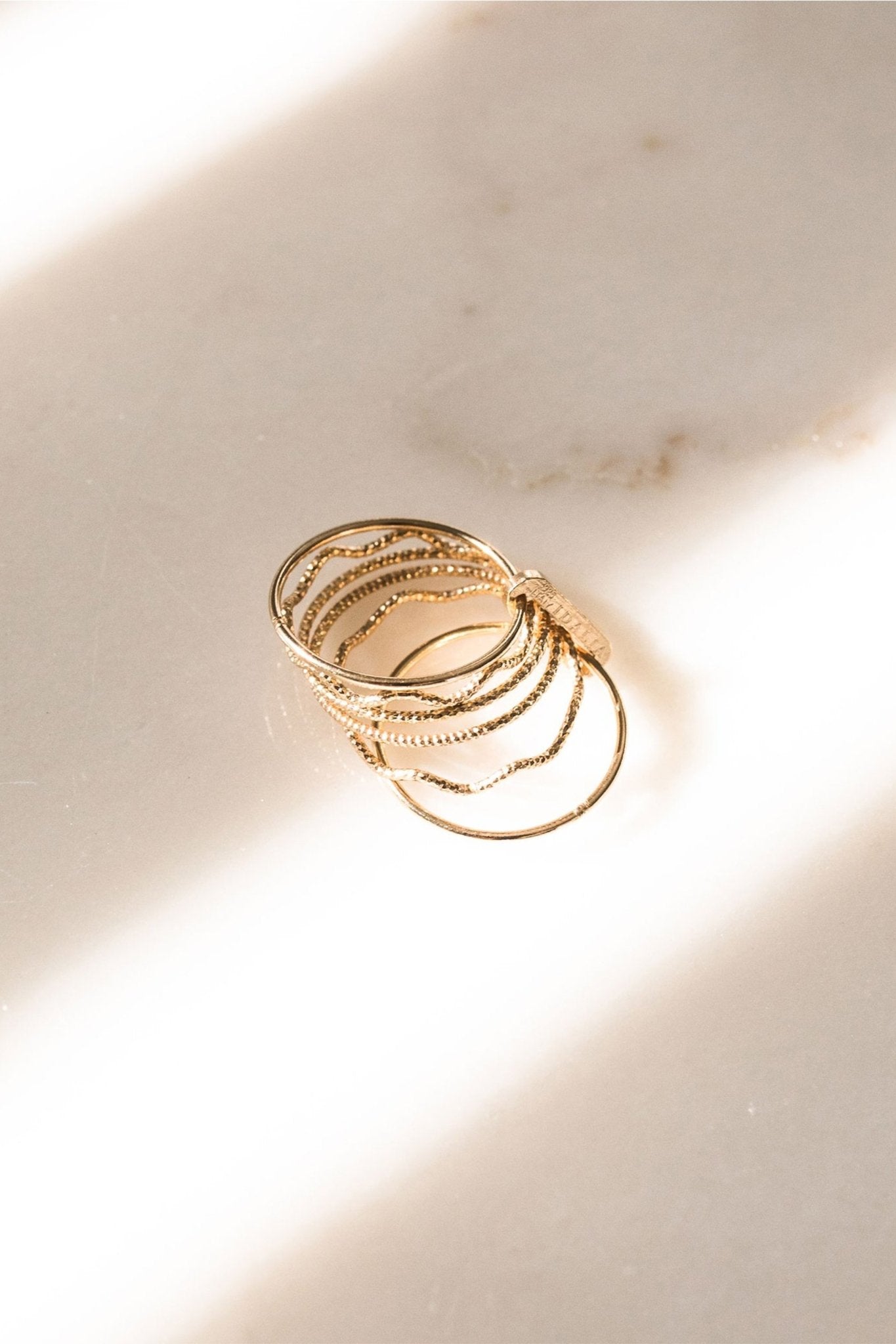 The Wave Stack Ring in gold on a white background- L'Atelier Global