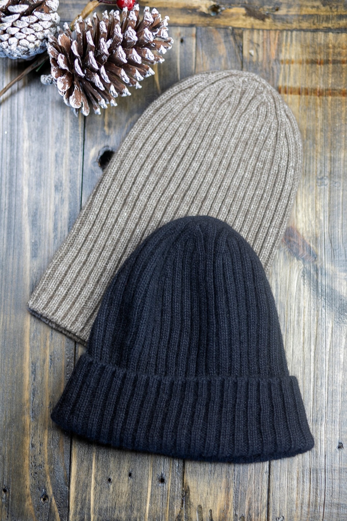 The American Bison Wool Silk Ribbed Beanie in black and natural on wood, snowy pinecone on top left corner - L'Atelier Global