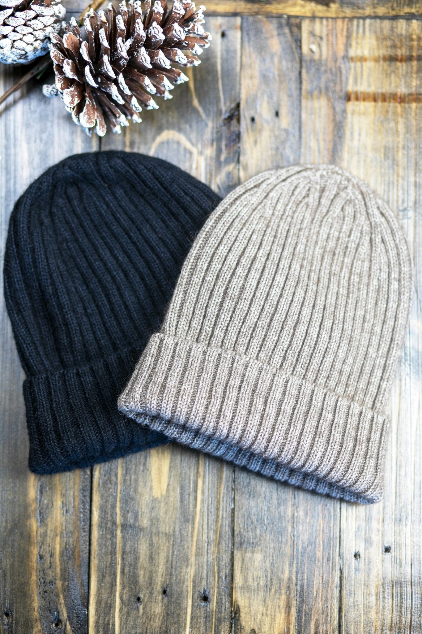 The American Bison Wool Silk Ribbed Beanie in black and natural on wood, snowy pinecone on top left corner - L'Atelier Global