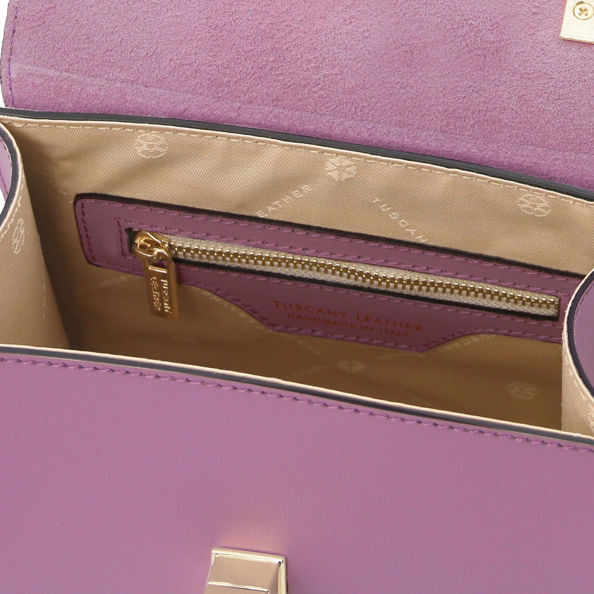 Interior view TL Bag Italian Leather Mini Bag in lilac showing interior zip pocket and beige lining. 