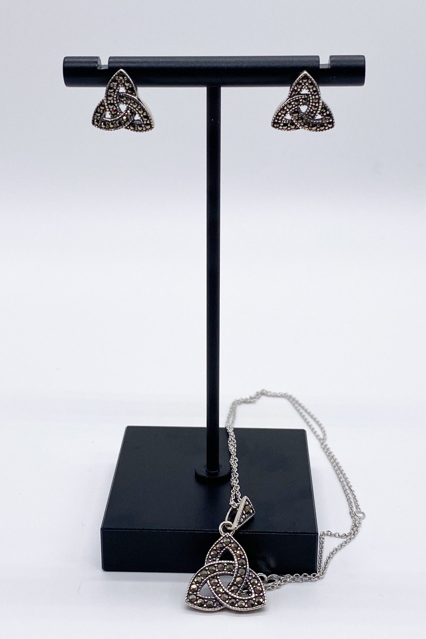 Trinity Knot Marcasite Pendant Necklace and earrings on a black jewelry stand - L'Atelier Global